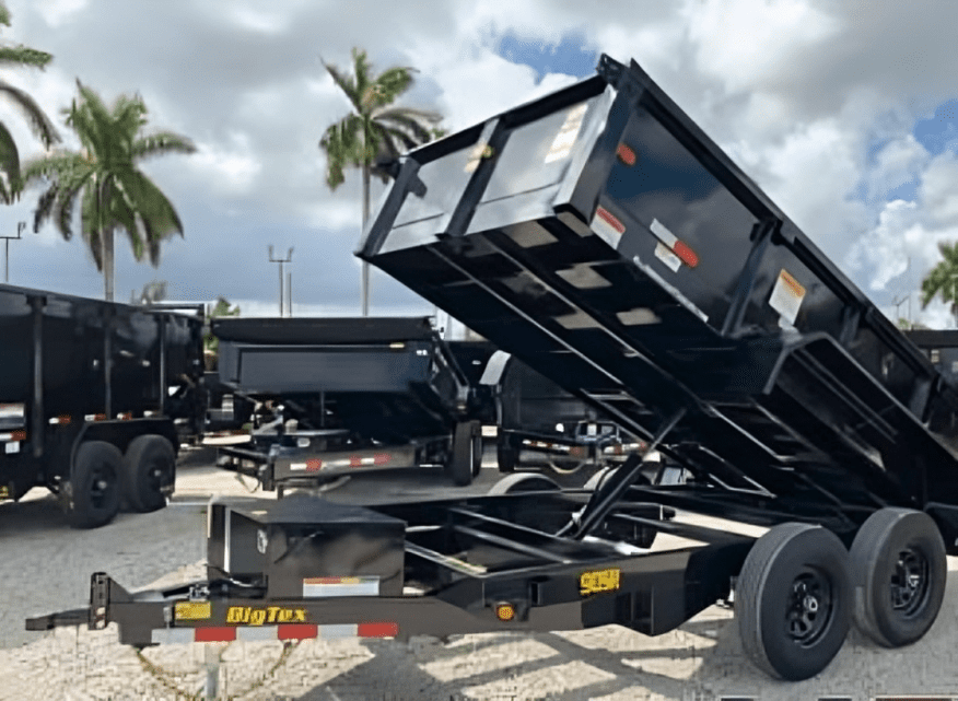 Dump trailers with palm trees in background.